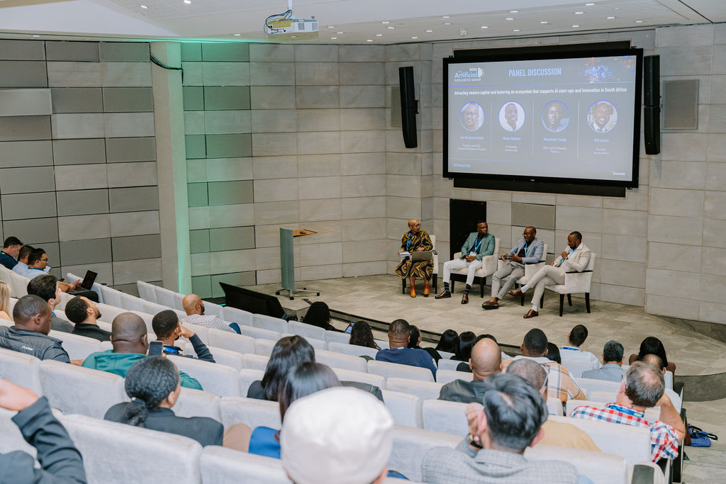 Gift Lubele on the panel at an Artificial Intelligence Summit in South Africa. Photograph.